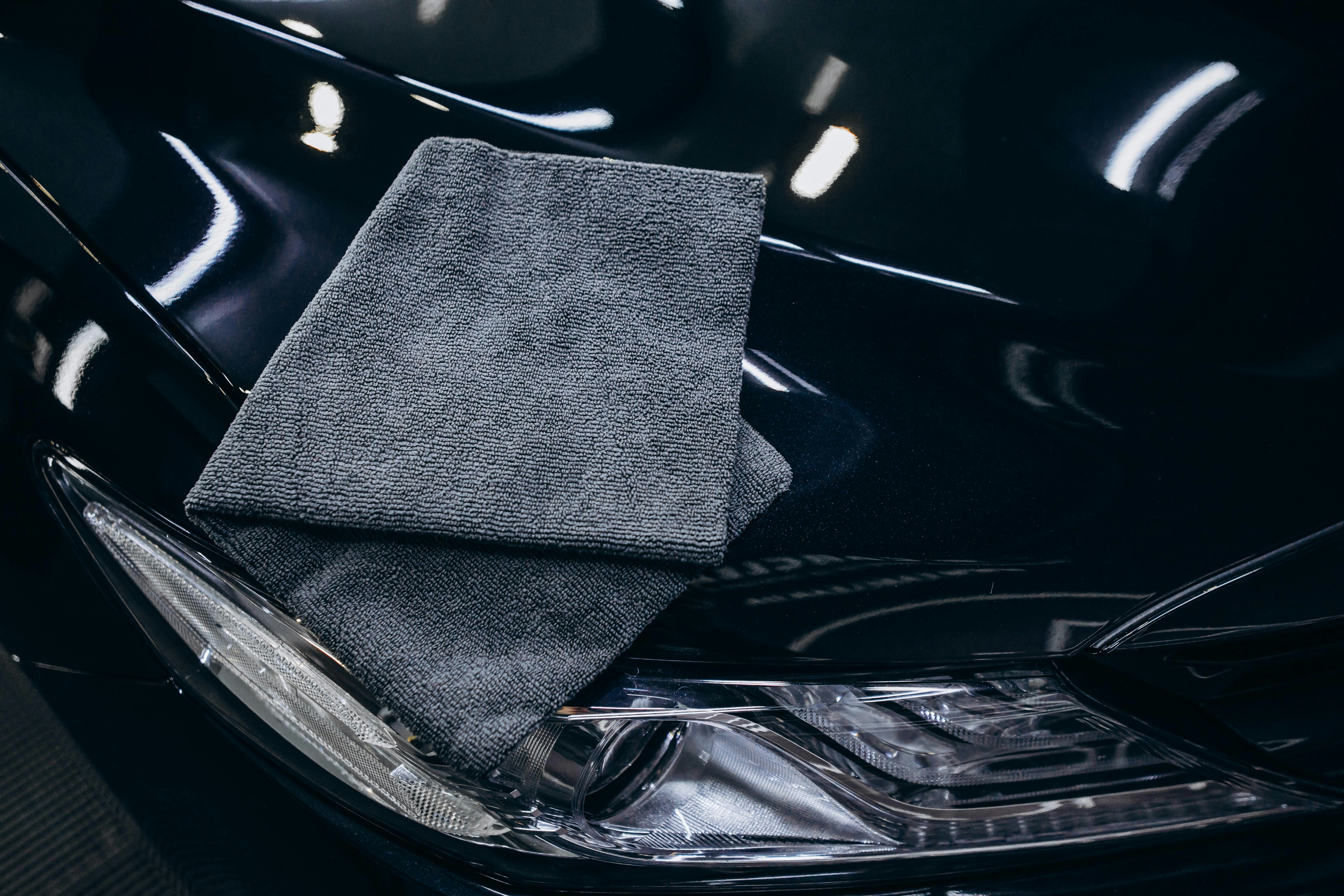 Detailing supplies including microfiber cloths and polishing equipment used in professional paint correction