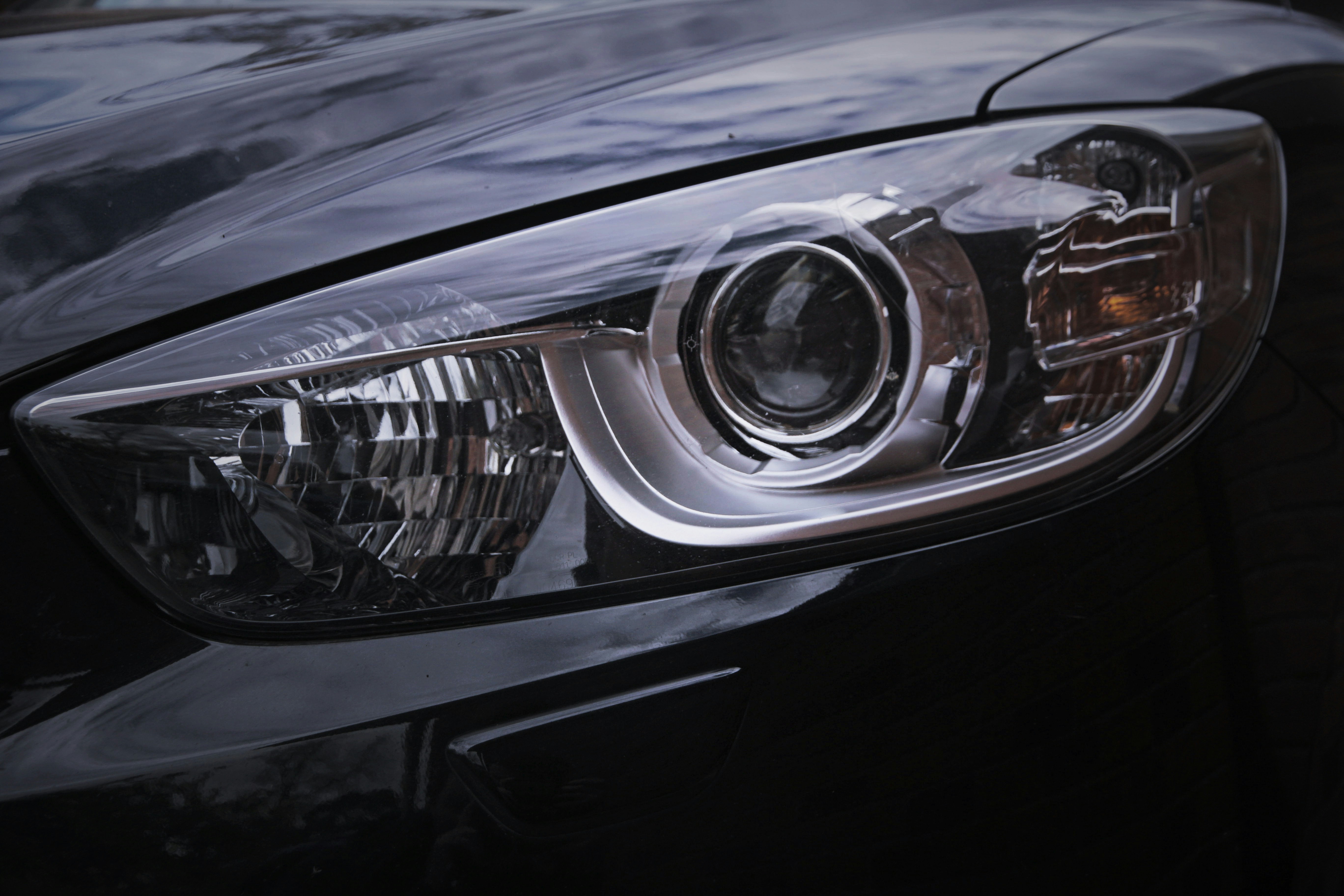 Close-up macro detail of a vehicle headlight showcasing precision automotive detailing