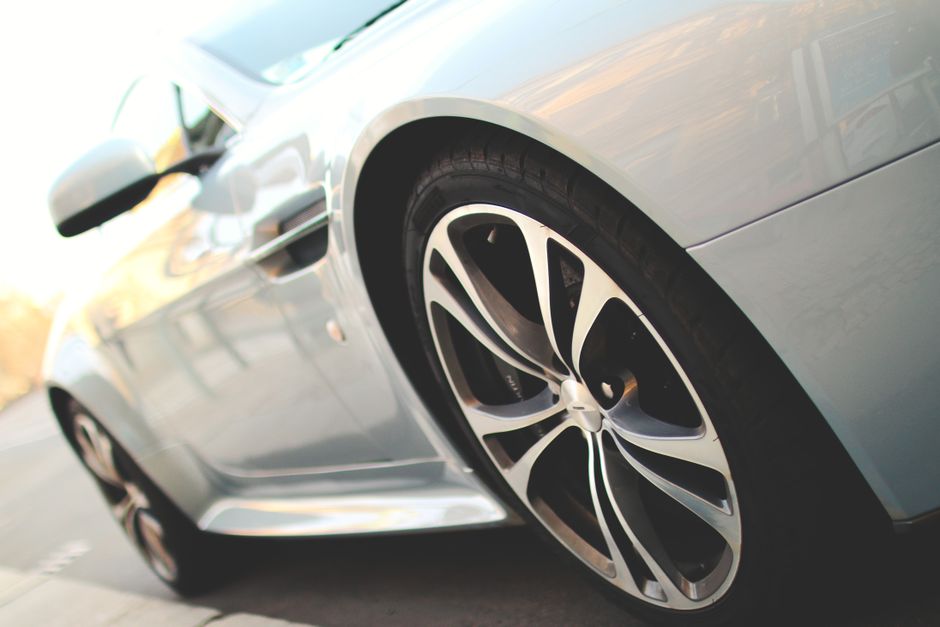 Close-up professional detailing of luxury car wheels and tires